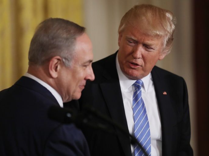 U.S. President Donald Trump (R) looks to Israeli Prime Minister Benjamin Netanyahu hold a joint news conference at the White House in Washington, U.S., February 15, 2017. REUTERS/Carlos Barria