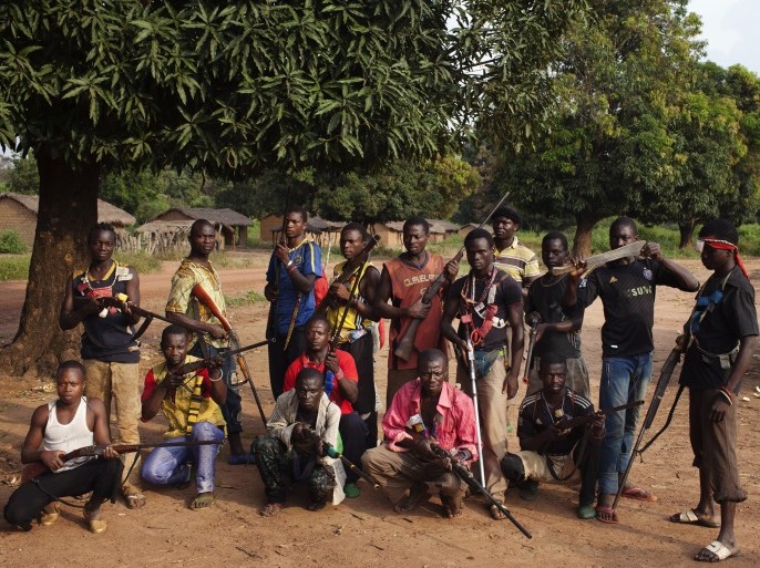 Militia fighters known as anti-balaka pose for a photograph in Mbakate village, Central African Republic November 25, 2013. They say they are protecting their village from Seleka fighters. With the country slipping deeper into chaos, former colonial power France plans to boost its force there to around 1,000 troops to restore law and order until a much bigger African Union force fully deploys. The land-locked country has been gripped by violence since the mainly Muslim rebels, many of them fighters from neighbouring Sudan and Chad, seized power in the majority Christian country in March. Some 460,000 people - around a tenth of the population - have fled the sectarian violence their takeover ignited. Picture taken November 25, 2013. REUTERS/Joe Penney (CENTRAL AFRICAN REPUBLIC - Tags: CIVIL UNREST SOCIETY POLITICS) ATTENTION EDITORS: PICTURE 21 OF 31 FOR PACKAGE 'TURMOIL IN CENTRAL AFRICAN REPUBLIC' TO FIND ALL IMAGES SEARCH 'PENNEY TURMOIL'