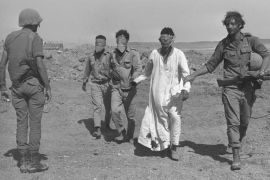 SINAI DESERT, EGYPT - OCTOBER 21: (FILE PHOTO) An Israeli army soldier leads blindfolded Egyptian prisoners-of-war October 21, 1973 in the Sinai Desert during the Yom Kippur War. Israeli Prime Minister Ariel Sharon, then an Israeli general, refused to rule out another surprise attack similar to the one launched by the Arab armies when they struck against Israeli troops in the Sinai Desert and Golan Heights on the holiest day of the Jewish calendar on October 6, 1973. (Photo by Ilan Ron/GPO/Getty Images)