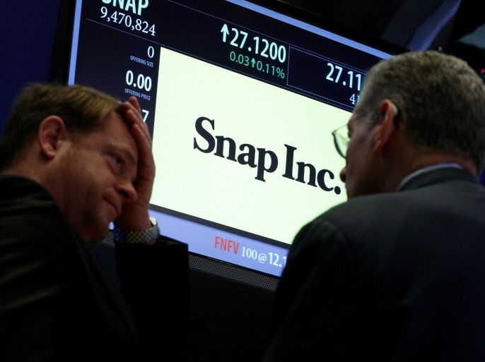 Traders gather at the post where Snap Inc. is traded on the floor of the New York Stock Exchange (NYSE) in New York, U.S., March 6, 2017. REUTERS/Brendan McDermid
