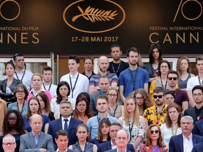 •70th Cannes Film Festival - Tribute for Manchester - Cannes, France. 23/05/2017. Cannes Film Festival general delegate Thierry Fremaux, Cannes Film festival president Pierre Lescure, actress Isabelle Huppert and staff members observe a minute of silence on the red carpet. REUTERS/Jean-Paul Pelissier