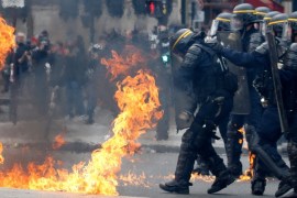 French CRS riot police protect themselves from flames during clashes at the traditional May Day labour union march in Paris, France, May 1, 2017. REUTERS/Gonzalo Fuentes