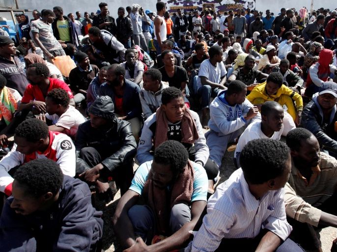 Illegal African migrants sit during a visit by U.N. Special Representative and Head of the United Nations Support Mission in Libya Martin Kobler and International Organization for Migration Director General William Lacy Swing at a detention camp in Tripoli, Libya, March 22, 2017. REUTERS/Ismail Zitouny