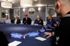 U.S. President Donald Trump (C, in red hat) and Defense Secretary James Mattis (3rd L) receive a briefing with Commanding Officer U.S. Navy Captain Rick McCormack (2nd R) and Susan Ford Bales (R) aboard the pre-commissioned U.S. Navy aircraft carrier Gerald R. Ford at Huntington Ingalls Newport News Shipbuilding facilities in Newport News, Virginia, U.S. March 2, 2017. REUTERS/Jonathan Ernst