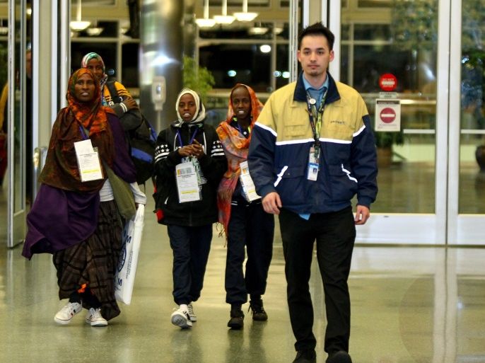 Safiya Hassan, Dahaba Matan, Farduwsa Matan, and Nima Matan, refugees from Somalia, are escorted by a United Airlines representative before being met by their U.S.-based family members on arrival at the airport in Boise, Idaho, U.S. March 10, 2017. REUTERS/Brian Losness