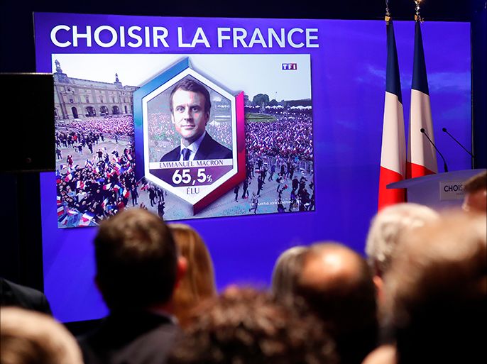 epa05949165 Candidate for the 'En Marche!' (Onwards!) political movement, Emmanuel Macron is seen on the screen before the speech of French presidential election candidate for the far-right Front National (FN) party, Marine Le Pen after the result of the second round of the French presidential elections at the Chalet du Lac in Paris, France, 07 May 2017. French presidential election candidate for the 'En Marche!' (Onwards!) political movement, Emmanuel Macron defeated Marine Le Pen in the final round of France's presidential election, with exit polls indicating that Macron is leading with approximately 65.5 per cent of the vote. EPA/IAN LANGSDON