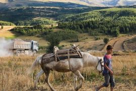 A boy works on the family farm in an area of Albania from where many young people have fled abroadELIE GARDNER