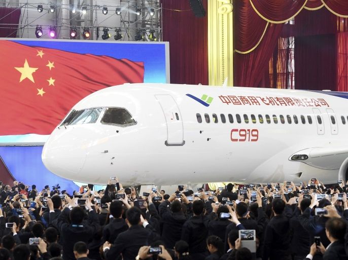 The first C919 passenger jet made by the Commercial Aircraft Corp of China (Comac) is pulled out during a news conference at the company's factory in Shanghai, November 2, 2015. Comac rolled out China's first homemade 158-seated C919 narrow body jet, which is meant to rival similar models from Airbus Group and Boeing Co. State television also showed footage of the aircraft rolling off the assembly line in Comac's Shanghai factory. In a statement, the company said it