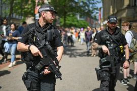 MANCHESTER, ENGLAND - MAY 25: Armed police patrol as members of the public queue to lay flowers in St Ann's Square in memory of those who lost their lives in the Manchester Arena attack, on May 25, 2017 in Manchester, England. An explosion occurred at Manchester Arena on the evening of May 22 as concert goers were leaving the venue after Ariana Grande had performed. Greater Manchester Police are treating the explosion as a terrorist attack and have confirmed 22 fatali