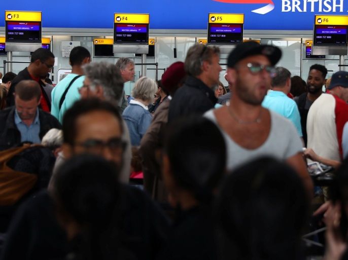 People wait with their luggage at the British Airways check in desks at Heathrow Terminal 5 in London, Britain May 28, 2017. REUTERS/Neil Hall