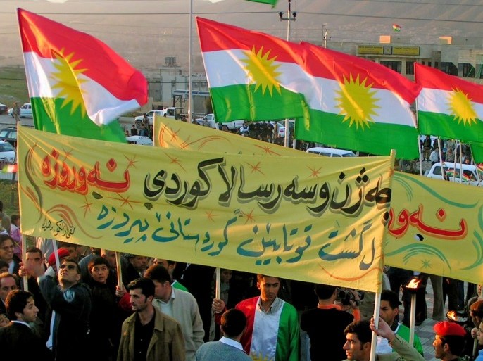 Iraqi Kurds carry Kurdish flags as they march during New Year celebrations near the northern Iraqi town of Arbil March 20, 2006. Kurds around the world celebrate the arrival of spring with the traditional Nawroz celebration. Picture taken March 20, 2006. REUTERS/Azad Lashkari