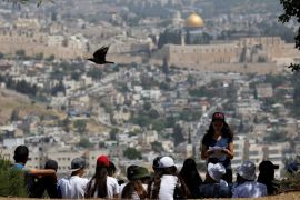 A crow flies past as Jewish school children gather at a look-out point on the Armon Hanatziv Promenade in Jerusalem May 11, 2017. Picture taken May 11, 2017. REUTERS/Amir Cohen