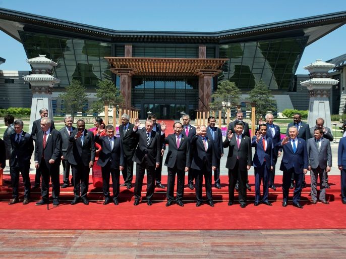Leaders attending the Belt and Road Forum wave as they pose for a group photo at the Yanqi Lake venue on the outskirt of Beijing, China, May 15, 2017. REUTERS/Ng Han Guan/Pool