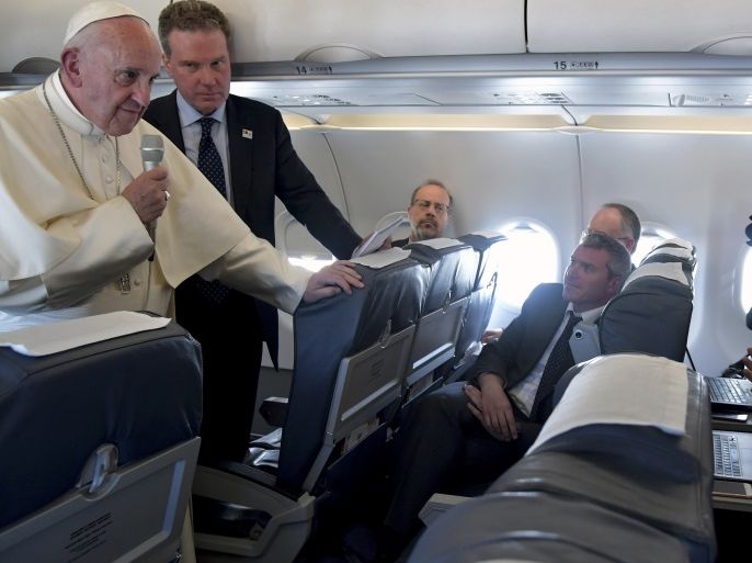 Pope Francis speaks to reporters as he flies back to Rome following the visit at the Holy Shrine of Fatima in Portugal May 13, 2017. REUTERS/Tiziana Fabi/Pool