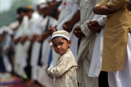 epaselect epa06050863 A Muslim boy reacts as Muslim devotees offer Eid al-Fitr prayers outside the Khairudin mosque in Amritsar, India, 26 July 2017. Muslims around the world celebrate the Eid al-Fitr festival, which marks the end of the Muslim fasting month of Ramadan and is celebrated with prayers, readings from the Koran and gatherings with family and friends. EPA/RAMINDER PAL SINGH
