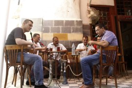 Syrian men sit at a coffee shop in old Damascus, September 8, 2013. REUTERS/Khaled al-Hariri (SYRIA - Tags: POLITICS CONFLICT CIVIL UNREST SOCIETY)