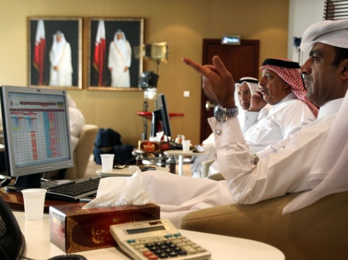 Traders monitor screens displaying stock information at Qatar Stock Exchange in Doha, Qatar November 9, 2016. REUTERS/Naseem Zeitoon