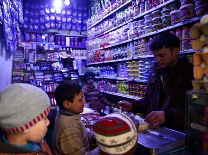 Boys buy goods from a grocery shop in the rebel held besieged city of Douma, in the eastern Damascus suburb of Ghouta, Syria February 12, 2017. REUTERS/Bassam Khabieh