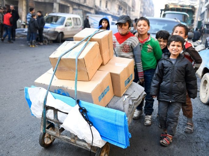 Children push a cart carrying relief items provided by UNHCR and other UN partners in the east Aleppo neighborhood of Tariq al-Bab, in this handout picture provided by UNHCR on January 4, 2017. Bassam Diab/UNHCR/Handout via Reuters REUTERS ATTENTION EDITORS - THIS PICTURE WAS PROVIDED BY A THIRD PARTY. REUTERS IS UNABLE TO INDEPENDENTLY VERIFY THE AUTHENTICITY, CONTENT, LOCATION OR DATE OF THIS IMAGE. FOR EDITORIAL USE ONLY. TPX IMAGES OF THE DAY