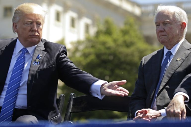 President Donald Trump reaches out toward Attorney General Jeff Sessions as they attend the National Peace Officers Memorial Service on the West Lawn of the U.S. Capitol in Washington, U.S., May 15, 2017. REUTERS/Kevin Lamarque