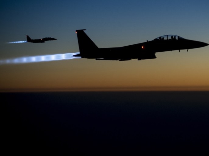 A pair of U.S. Air Force F-15E Strike Eagles fly over northern Iraq after conducting airstrikes in Syria, in this U.S. Air Force handout photo taken early in the morning of September 23, 2014. These aircraft were part of a large coalition strike package that was the first to strike ISIL targets in Syria. At least 14 Islamic State fighters were killed in air strikes by U.S.-led forces overnight in northeast Syria, a group monitoring the war said on September 25, 2014, an