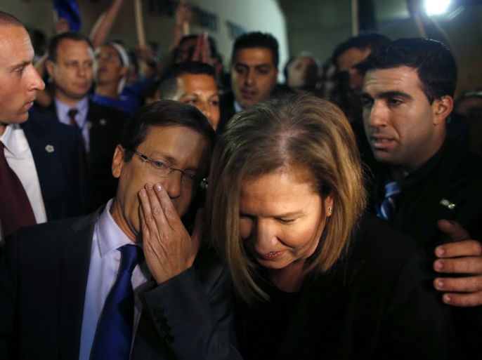 Isaac Herzog (L) speaks with Tzipi Livni, his co-leader of the center-left Zionist Union party, while campaigning outside a polling station in Modiin near Tel Aviv March 17, 2015. Millions of Israelis turned out to vote on Tuesday in a tightly-fought election, with Prime Minister Benjamin Netanyahu facing an uphill battle to defeat a strong campaign by the centre-left opposition to deny him a fourth term in office. When the last opinion polls were published on March 13, the centre-left Zionist Union led by Herzog held a four-seat lead over Netanyahu's Likud, a margin that had the opposition set for a surprise victory. REUTERS/Ronen Zvulun (ISRAEL - Tags: POLITICS ELECTIONS TPX IMAGES OF THE DAY)