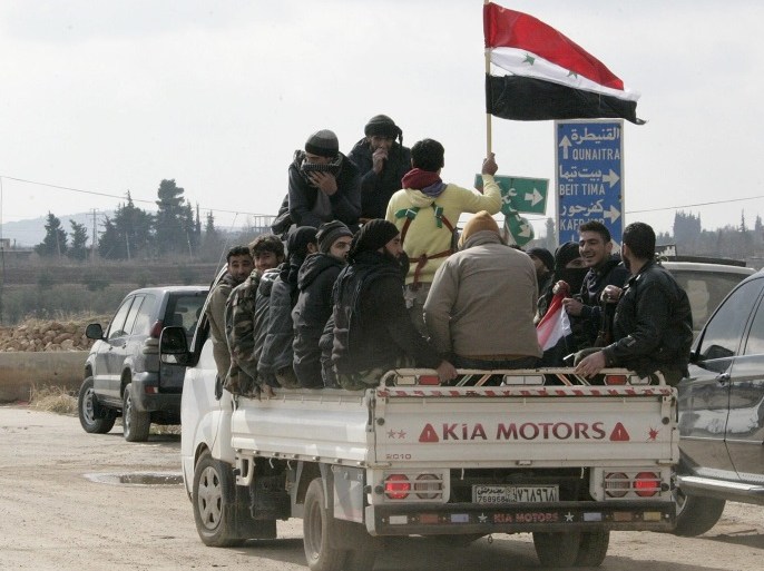 A handout picture made available by Syrian Arab news agency shows Syrian gunmen carry the Syrian national flag as they sit aboard a truck after registering their names and hand over their weapons to get a legal status in the southwestern countryside of Damascus, Syria, 05 January 2017. SANA reporter said 200 gunmen from Beit Saber, Beit Tima, Saasaa al-Gharbiyeh, Hassno and Kafar Hour in the western part of Damascus Countryside had turned themselves in and handed over their weapons to the authorities and pledged to not get involved in any act that might harm the homeland's security in the future. Chairman of the Local Reconciliation Committee in the countryside of Damascus and Daraa Mou'men Jarida said the region will be fuly cleared of gunmen and arms so that the state establishments will operate normally again. EPA/SANA HANDOUT HANDOUT EDITORIAL USE ONLY/NO SALES