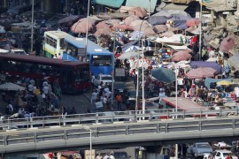 People are seen at a market amidst a traffic jam in downtown Cairo May 22, 2014. Days before a presidential election he seems certain to win, Abdel Fattah al-Sisi released a detailed, colour-coded rendering of