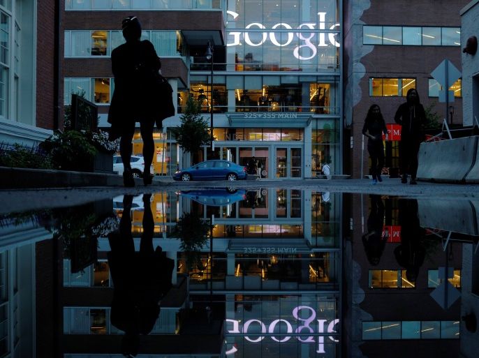 The Google sign is reflected in a rain puddle outside their offices in Cambridge, Massachusetts, U.S., June 27, 2017. REUTERS/Brian Snyder