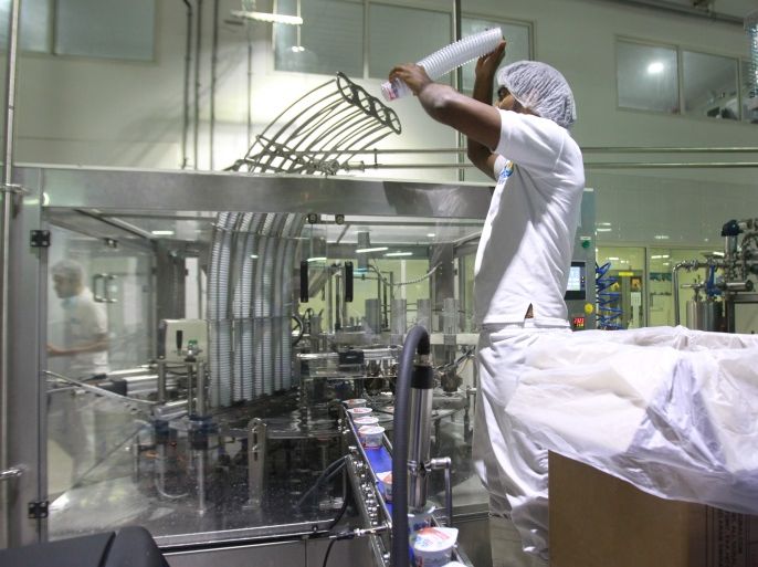 A worker works in a dairy factory in Doha, Qatar, June 10, 2017. REUTERS/Naseem Zeitoon