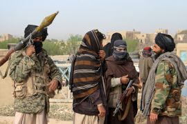 Members of the Taliban gather at the site of the execution of three men accused of murdering a couple during a robbery in Ghazni Province April 18, 2015. The Taliban announced the execution of the three men accused of murdering a couple during a robbery, saying they had been tried by an Islamic court. The killing was carried out in front of a crowd by Taliban fighters who fired at the men with AK-47s, according to a Reuters witness. Footage seen by Reuters show the men