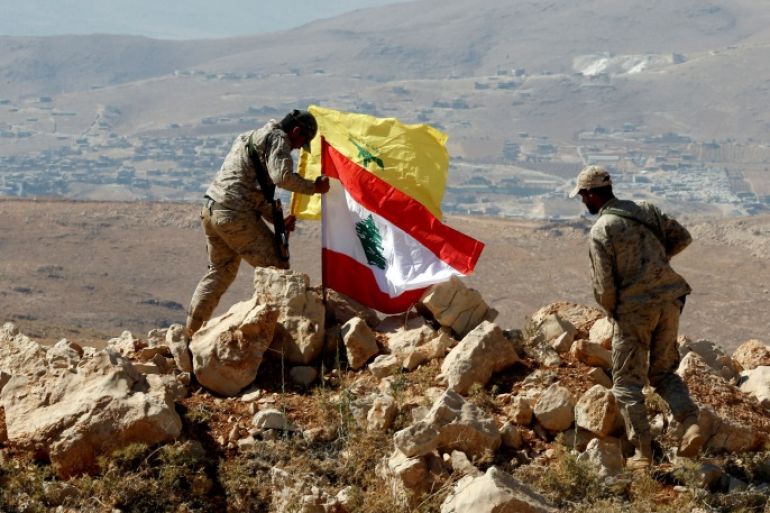 Hezbollah fighters put Lebanese and Hezbollah flags at Juroud Arsal, Syria-Lebanon border, July 25, 2017. Picture taken July 25, 2017. REUTERS/Mohamed Azakir TPX IMAGES OF THE DAY