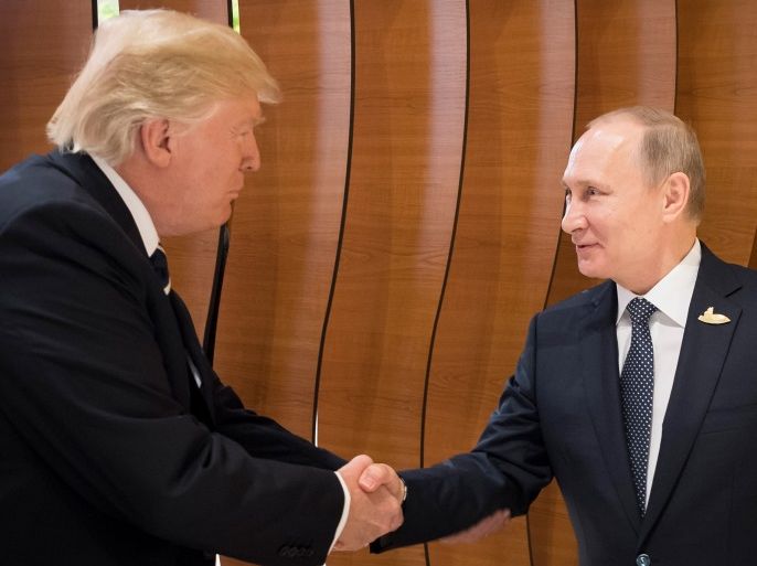 President Donald J. Trump (L) shaking hands with Russian President Vladimir Putin during the G20 summit in Hamburg