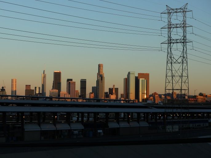 The skyline of L.A. is pictured under industrial power lines in the early morning light of Los Angeles, California, U.S., March 6, 2017. REUTERS/Mike Blake
