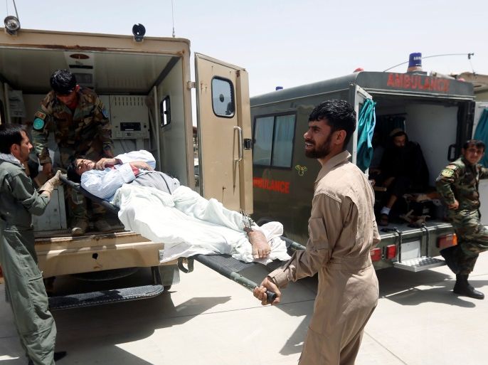 Afghan military medical personnel take an injured member of the Afghan security forces off an ambulance, prior to air transport for treatment in Kabul, at the Kandahar military Airport, Afghanistan July 9, 2017. Picture taken on July 9, 2017. REUTERS/Omar Sobhani