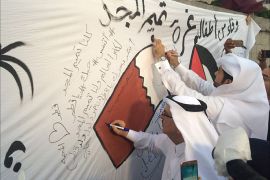 السفير القطري خلال توقيع على جدارية تضامن من أطفال غزة مع قطر