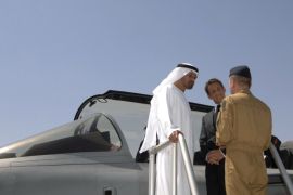 France's President Nicolas Sarkozy (C) and Abu Dhabi's Crown Prince Sheikh Mohamed bin Zayed al-Nahayan (L) chat with a member of the military near one of the jets at Dhafra air base in Abu Dhabi May 26, 2009. REUTERS/WAM/Handout (UNITED ARAB EMIRATES ROYALS POLITICS MILITARY) FOR EDITORIAL USE ONLY. NOT FOR SALE FOR MARKETING OR ADVERTISING CAMPAIGNS