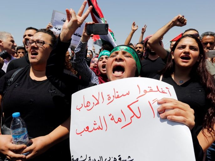 Protestors chant slogans during a demonstration near the Israeli embassy in Amman, Jordan July 28, 2017. The poster reads