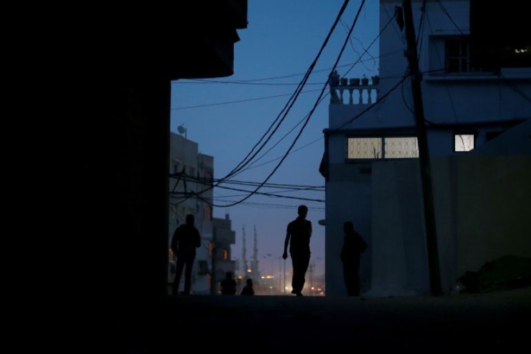 A Palestinian man walks during power cut at Shati refugee camp in Gaza City April 25, 2017. Picture taken April 25, 2017. REUTERS/Mohammed Salem