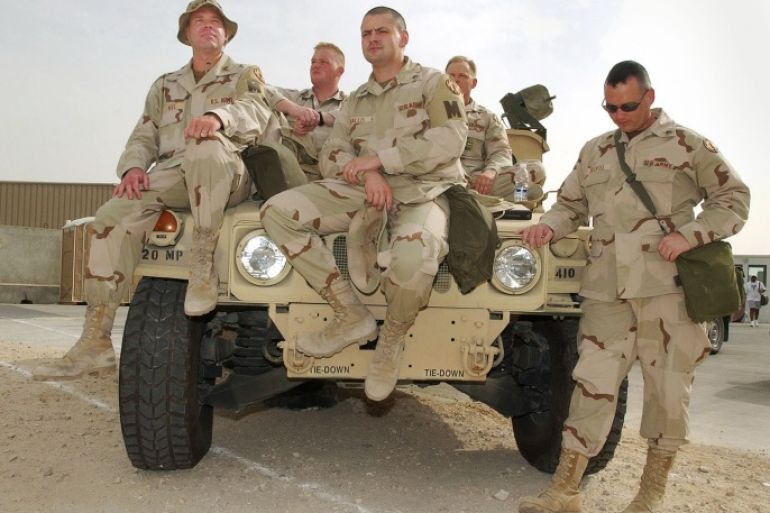 DOHA, QATAR - MARCH 20: (CANADA OUT) The 410 Military Police Company, from Fort Hood, Texas, watch the media and provide base security at Camp As Saliyah in Doha, Qatar March 20, 2003. The base is the site of the United States Central Command. (Photo by Carlo Allegri/Getty Images)