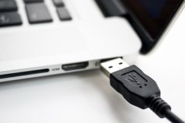 A photo illustration shows a USB device being plugged into a laptop computer in Berlin July 31, 2014. USB devices such as mice, keyboards and thumb-drives can be used to hack into personal computers in a potential new class of attacks that evade all known security protections, German crypto specialist and chief scientist with Berlin's SR Labs Karsten Nohl revealed on Thursday. REUTERS/Thomas Peter (GERMANY - Tags: CRIME SCIENCE TECHNOLOGY)
