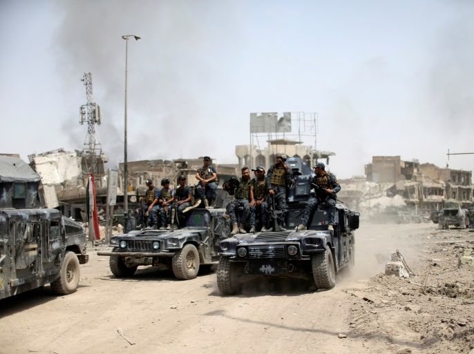 Iraqi Federal Police members ride in military vehicles during the fight with the Islamic State militants in the Old City of Mosul, Iraq July 4, 2017. REUTERS/Ahmed Jadallah