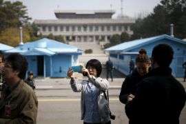 A foreign tourist takes a selfie at the truce village of Panmunjom, South Korea, March 30, 2016. REUTERS/Kim Hong-Ji