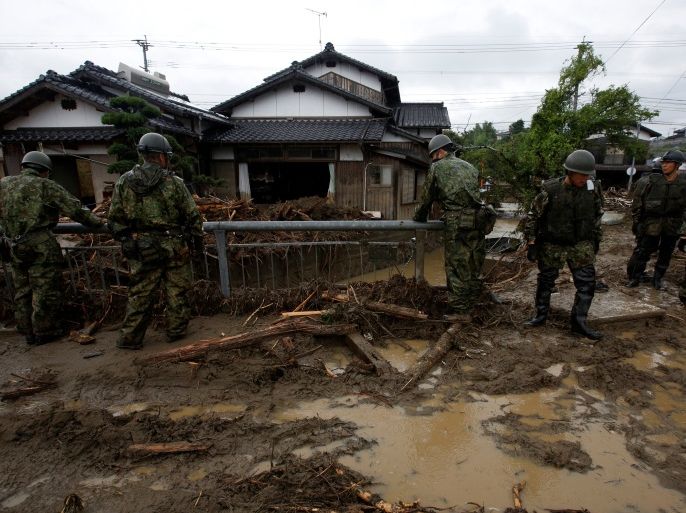 Japanese Self-Defense Force soldiers conduct search and rescue operation near houses damaged by a heavy rain in Asakura, Fukuoka Prefecture, Japan July 9, 2017. REUTERS/Issei Kato