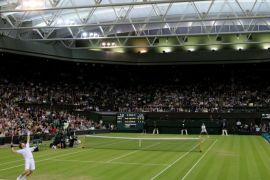 FILE PHOTO: Andy Murray of Britain (FOREGROUND) serves to Ivan Ljubicic of Croatia under the closed roof on Centre Court at the Wimbledon tennis championships in London, Britain, June 24, 2011. REUTERS/Stefan Wermuth/File Photo