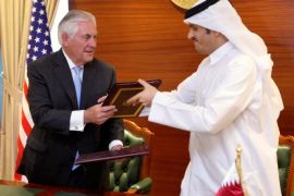 Qatar's foreign minister Sheikh Mohammed bin Abdulrahman al-Thani (R) and U.S. Secretary of State Rex Tillerson exchange a memorandum of understanding in Doha, Qatar, July 11, 2017. REUTERS/Naseem Zeitoon