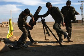 HASAKA, SYRIA - NOVEMBER 11: Troops from the Syrian Democratic Forces prepare to fire mortars on ISIL positions on the frontline on November 11, 2015 near Hasaka, in the autonomous region of Rojava, Syria. The armed forces of the mostly Kurdish region in northern Syria have been retaking territory from ISIL extremists with the help of airstrikes from U.S. led coalition warplanes. (Photo by John Moore/Getty Images)