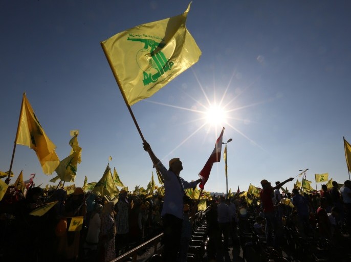 Supporters of Lebanon's Hezbollah leader Sayyed Hassan Nasrallah wave Hezbollah and Lebanese flags as they listen to him via a screen during a rally marking the 10th anniversary of the end of Hezbollah's 2006 war with Israel, in Bint Jbeil, southern Lebanon August 13, 2016. REUTERS/Aziz Taher