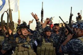 Iraqi soldiers celebrate in central Mosul, northern Iraq, 10 July 2017.
