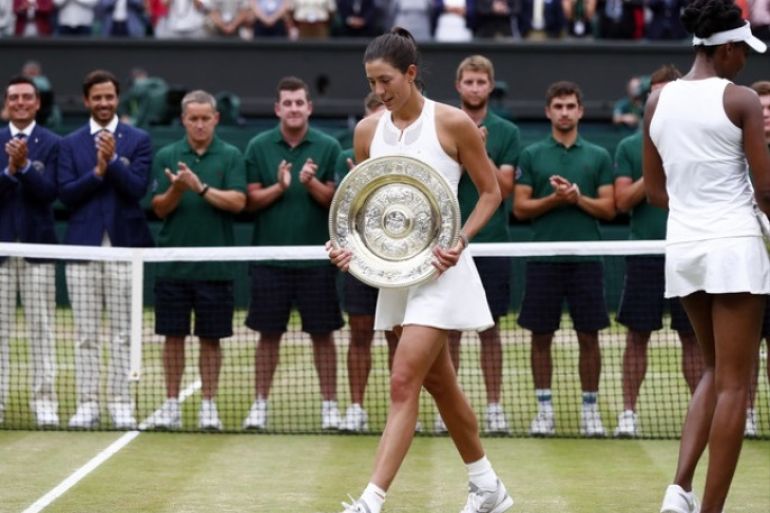 epa06089545 Garbine Muguruza of Spain with the championship trophy following her victory over Venus Williams of the US (R) in the women's final of the Wimbledon Championships at the All England Lawn Tennis Club, in London, Britain, 15 July 2017. EPA/NIC BOTHMA EDITORIAL USE ONLY/NO COMMERCIAL SALES